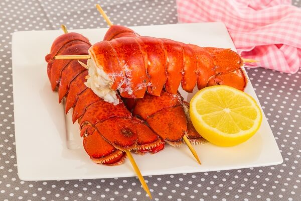 Boiled lobster tails served with lemon