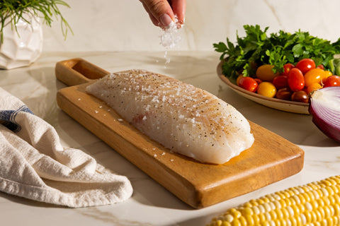 Seasoning Icelandic cod loin with salt and pepper