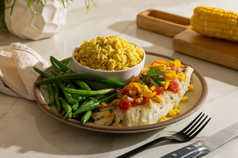 Pan-seared Icelandic cod with charred corn and tomatoes, green beans and rice pilaf